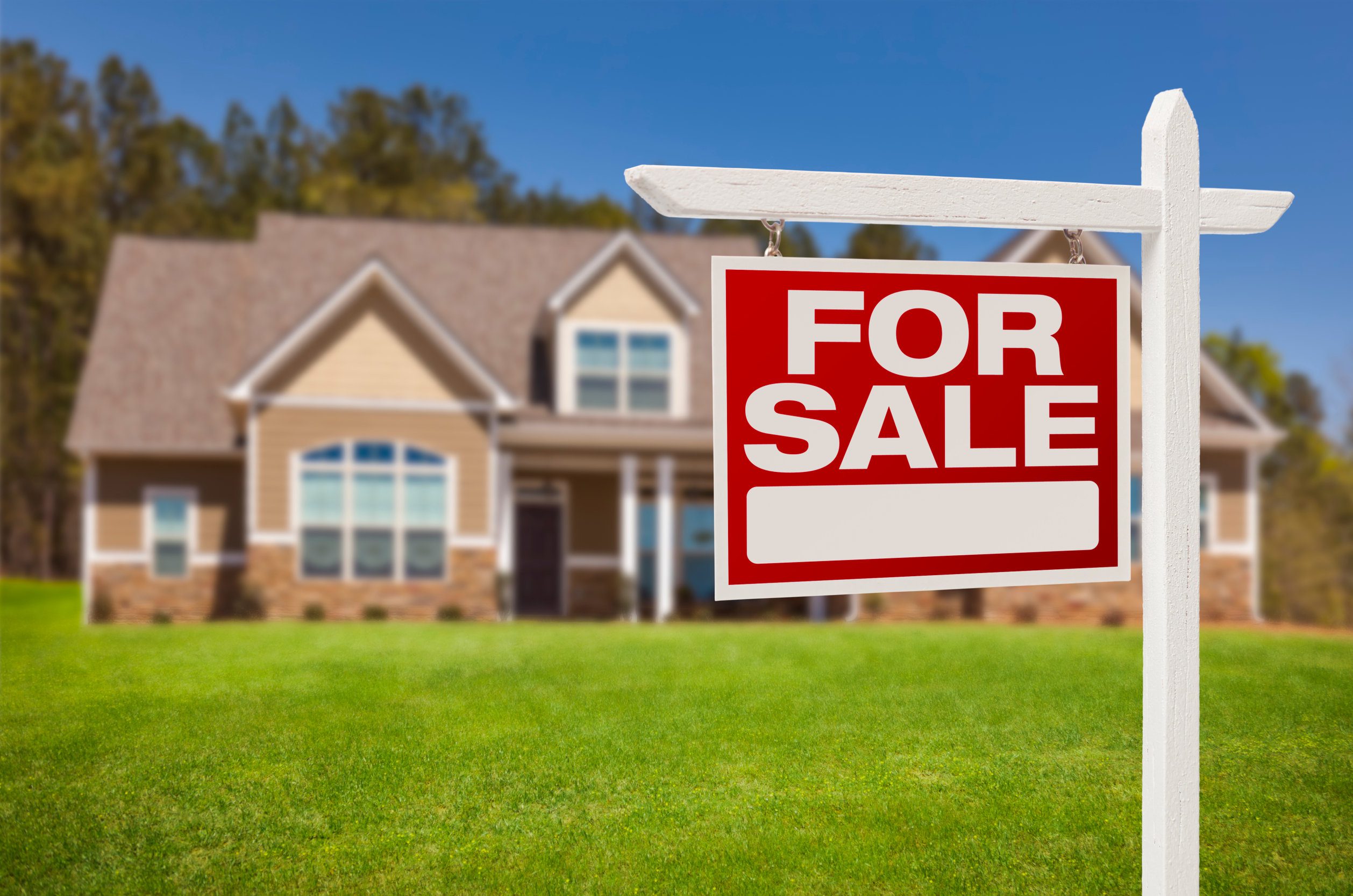 Home For Sale Real Estate Sign in Front of Beautiful New House. Home For Sale Real Estate Sign in Front of Beautiful New House.